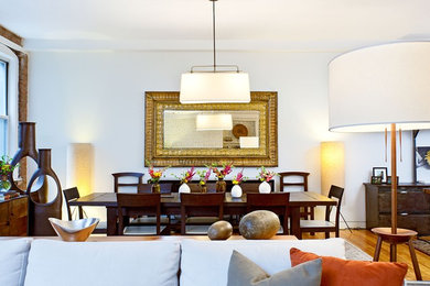 Dining room - rustic medium tone wood floor dining room idea in New York with white walls