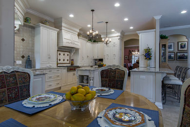 Design ideas for a large traditional u-shaped open plan kitchen in Tampa with raised-panel cabinets, white cabinets, granite benchtops, stone tile splashback, panelled appliances and with island.