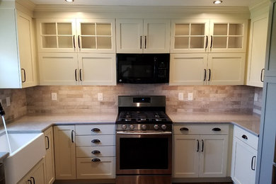 Inspiration for a mid-sized galley enclosed kitchen remodel in Other with a farmhouse sink, solid surface countertops, stainless steel appliances, no island and gray countertops