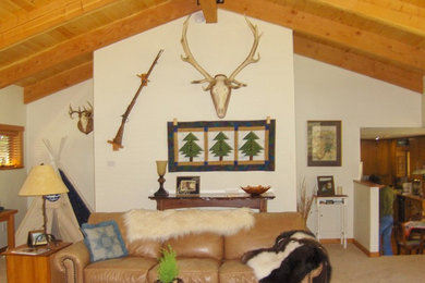 Example of a mountain style open concept carpeted living room design in Seattle with white walls