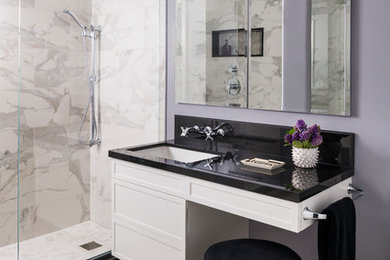 Inspiration for a small contemporary 3/4 bathroom in New York with purple walls, black benchtops, recessed-panel cabinets, white cabinets, an alcove shower, white tile, marble, marble floors, an undermount sink, white floor and solid surface benchtops.