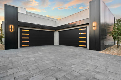 Inspiration for a large modern attached four-car garage remodel in Las Vegas