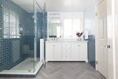 Mid-sized transitional 3/4 white tile and ceramic tile porcelain tile, gray floor and single-sink corner shower photo in Los Angeles with beaded inset cabinets, white cabinets, white walls, an undermount sink, marble countertops, a hinged shower door, white countertops, a niche and a freestanding vanity