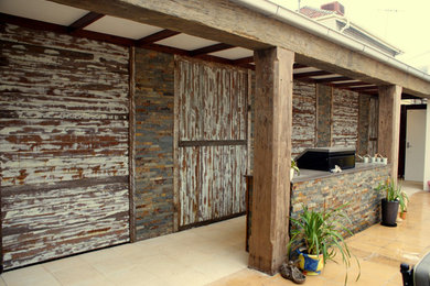 Photo of a large country exterior in Sydney with wood siding.