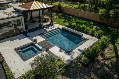 Pool - large eclectic backyard tile pool idea in Houston