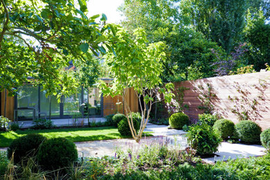 Photo of a mid-sized contemporary backyard formal garden in London with a garden path and gravel.