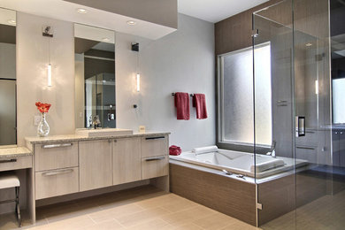 Inspiration for a large modern 3/4 beige tile, brown tile, white tile and mosaic tile bathroom remodel in Albuquerque with flat-panel cabinets, gray cabinets, a two-piece toilet, white walls, an undermount sink and granite countertops