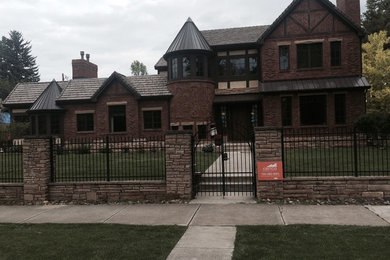 Large traditional three-story gable roof idea in Denver