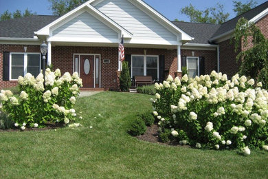 Inspiration for a large split-level brick exterior home remodel in Other