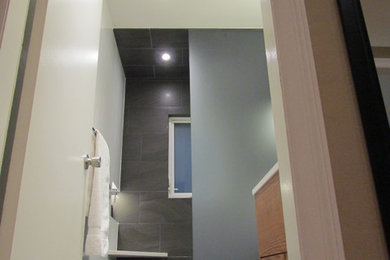 Bathroom - small modern 3/4 white tile and porcelain tile bathroom idea in Vancouver with flat-panel cabinets, white walls, dark wood cabinets, a two-piece toilet, a wall-mount sink and solid surface countertops