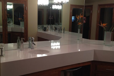 Inspiration for a large contemporary master travertine floor bathroom remodel in Other with an undermount sink, recessed-panel cabinets, medium tone wood cabinets and quartzite countertops