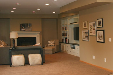 This is an example of a large transitional walk-out basement in Minneapolis with beige walls, carpet and a stone fireplace surround.