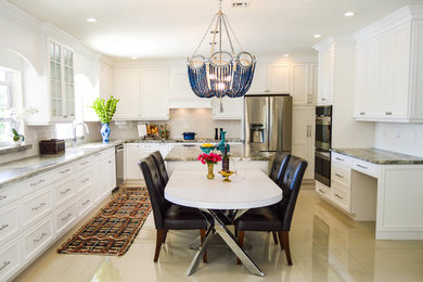 This is an example of a large transitional u-shaped eat-in kitchen in Miami with a farmhouse sink, raised-panel cabinets, white cabinets, granite benchtops, white splashback, subway tile splashback, stainless steel appliances, porcelain floors and with island.