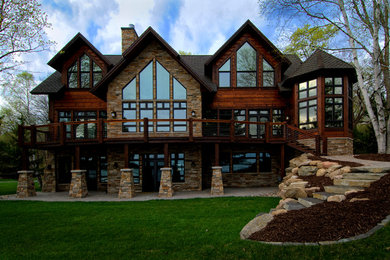 Expansive traditional two-storey brown exterior in Minneapolis with wood siding.