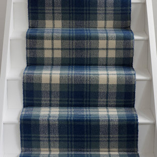 Example of a trendy painted straight staircase design in Hampshire with painted risers