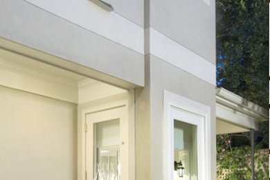 Example of a large transitional gray two-story stucco house exterior design in Houston with a shingle roof