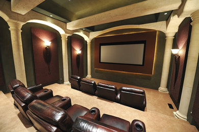 This is an example of a large contemporary enclosed home theatre in Minneapolis with beige walls and a projector screen.