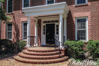 Example of a mid-sized classic brick floor entryway design in Richmond with a black front door