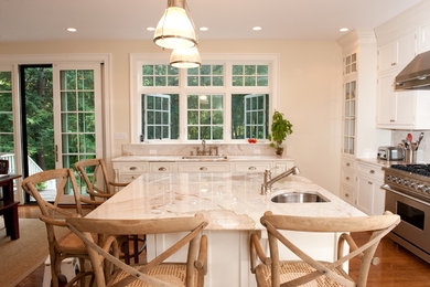 Large elegant u-shaped dark wood floor and brown floor open concept kitchen photo in Boston with an undermount sink, shaker cabinets, white cabinets, marble countertops, beige backsplash, marble backsplash, stainless steel appliances and an island