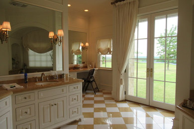 Example of a large classic master marble floor bathroom design in Dallas with furniture-like cabinets, white cabinets, white walls, an undermount sink, marble countertops, a hinged shower door and beige countertops