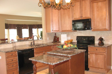 Elegant u-shaped ceramic tile enclosed kitchen photo in St Louis with a double-bowl sink, raised-panel cabinets, medium tone wood cabinets, granite countertops, beige backsplash, ceramic backsplash, black appliances and an island