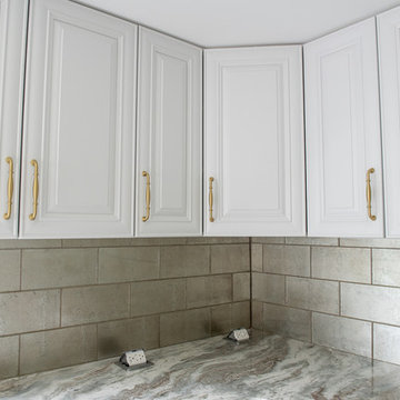 Transitional Kitchen Done in a 2 Tone Color With Integrated Dining Table