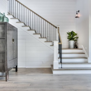 Photo of a medium sized and mixed farmhouse wood l-shaped staircase in Orange County with painted wood risers.