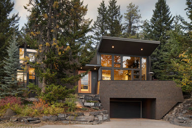 Inspiration for a large contemporary two-storey brown house exterior in Calgary.