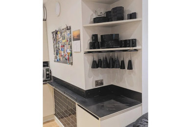 Kitchen drinks area and bespoke bin drawer.