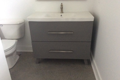 Example of a minimalist single-sink bathroom design in Nashville with flat-panel cabinets, gray cabinets and a freestanding vanity