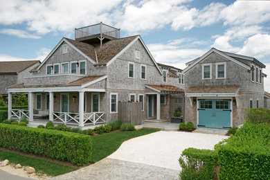 Inspiration for a beach style two-storey brown exterior in Other with wood siding and a gable roof.