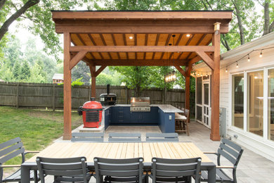 Patio kitchen - large transitional backyard concrete paver patio kitchen idea in Chicago with a pergola