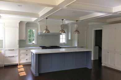 Eat-in kitchen - large traditional single-wall medium tone wood floor and brown floor eat-in kitchen idea in New York with a farmhouse sink, flat-panel cabinets, white cabinets, marble countertops, gray backsplash, porcelain backsplash, paneled appliances, an island and gray countertops