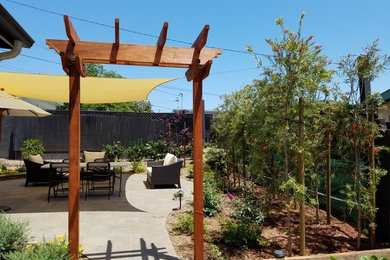 Design ideas for a mid-sized traditional full sun backyard concrete paver landscaping in San Diego.