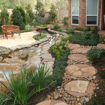 Landscaping with oversize pavers and backyard creek - hkns
