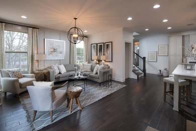 Photo of a transitional formal open concept living room in Atlanta with beige walls, dark hardwood floors, a standard fireplace and a wall-mounted tv.