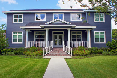 Inspiration for a mid-sized traditional two-storey blue exterior in Tampa with wood siding.