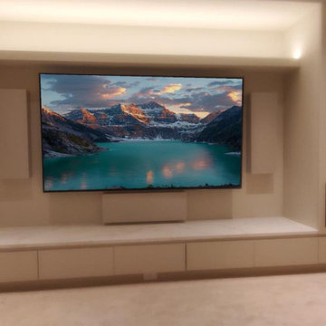 Stealth media wall with concealed speakers and cove lighting - Calgary