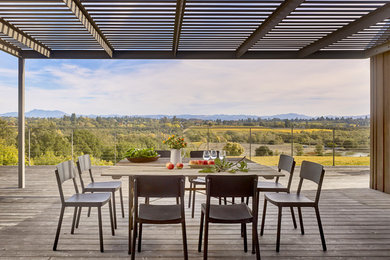 Example of a farmhouse side yard deck design in San Francisco with a pergola