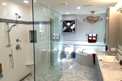 Bathroom - mid-sized transitional master gray tile and mosaic tile mosaic tile floor and gray floor bathroom idea in Dallas with recessed-panel cabinets, gray cabinets, a one-piece toilet, gray walls, a drop-in sink and granite countertops