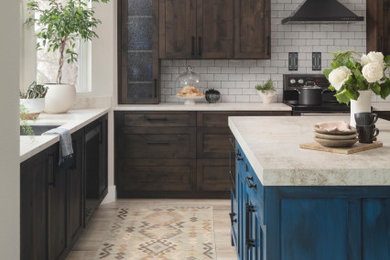 Inspiration for a mid-sized craftsman vinyl floor kitchen remodel in Denver with a single-bowl sink, shaker cabinets, distressed cabinets, solid surface countertops, white backsplash, ceramic backsplash, black appliances, an island and beige countertops