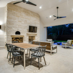 Design ideas for a country backyard patio in Dallas with a roof extension and with fireplace.