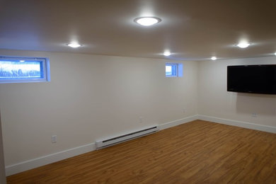 Inspiration for a large medium tone wood floor basement remodel in Portland Maine