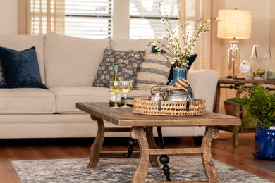Mid-sized transitional enclosed laminate floor and brown floor living room photo in Other with beige walls and a standard fireplace