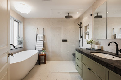 Inspiration for a modern master beige tile and porcelain tile porcelain tile, beige floor and single-sink bathroom remodel in Montreal with shaker cabinets, green cabinets, a one-piece toilet, beige walls, an undermount sink, quartz countertops, black countertops and a floating vanity