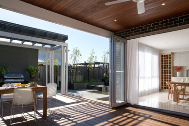 This is an example of a contemporary deck in Melbourne with a pergola.