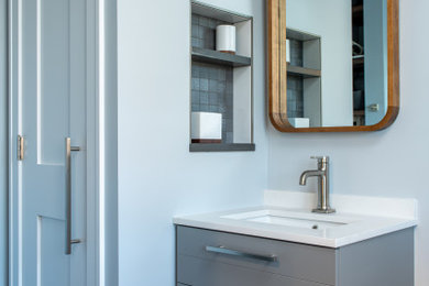 Inspiration for a medium sized traditional cloakroom in Chicago with flat-panel cabinets, grey cabinets, a two-piece toilet, white tiles, metro tiles, grey walls, porcelain flooring, a submerged sink, engineered stone worktops, grey floors, white worktops and a floating vanity unit.