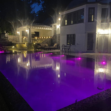 Ridgewood New Jersey Night View of Perimeter Overflow Swimming Pool & Landscapin