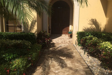 Mid-sized mediterranean front yard partial sun garden in Miami with a garden path and natural stone pavers.