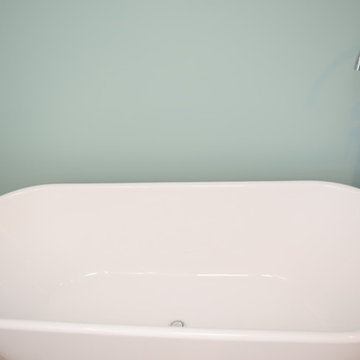 Free standing tub with floor mount faucet including a hand held.